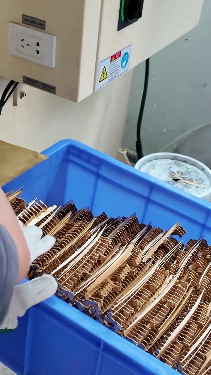 Stamped brass parts in a crate