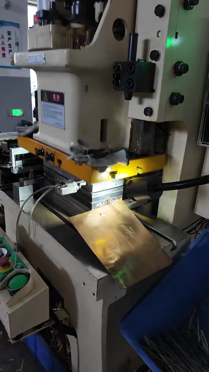Press running brass strip through a die