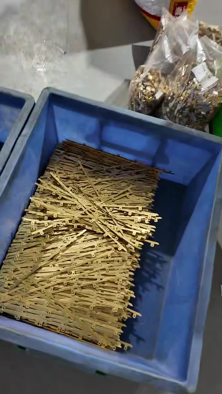 Crate of brass pins and small turned parts